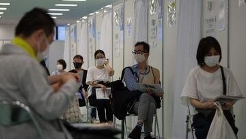 TOKYO, JAPAN - JUNE 30: People wait to receive the Moderna vaccine on June 30, 2021 in Tokyo, Japan. The Japanese government has begun an after-hours vaccination campaign as it expands its coronavirus inoculation drive to include younger people. (Photo by Carl Court/Getty Images)