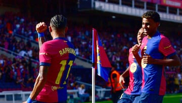 Barcelona's Brazilian forward #11 Raphinha celebrates scoring his team's first goal with Barcelona's Spanish forward #19 Lamine Yamal during the Spanish league football match between FC Barcelona and Real Valladolid FC at the Estadi Olimpic Lluis Companys in Barcelona on August 31, 2024. (Photo by MANU QUINTERO / AFP)