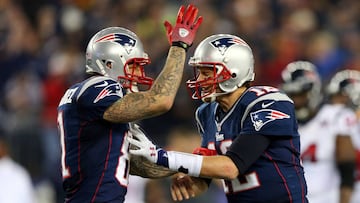 (FILES) This file photo taken on January 12, 2013 shows Aaron Hernandez #81 and Tom Brady #12 of the New England Patriots celebrating after a touchdown in the fourth quarter against the Houston Texans during the 2013 AFC Divisional Playoffs game at Gillette Stadium in Foxboro, Massachusetts.  
 Former American football star Aaron Hernandez on April 19, 2017 was found dead in prison where he was serving a life sentence for murder, after hanging himself with a bedsheet, prison officials said. Hernandez, 27, was discovered hanging in his cell by corrections officers in Shirley, Massachusetts at approximately 3:05 am (0705 GMT) Wednesday, Christopher Fallon with the Massachusetts Department of Correction said.&quot;Mr. Hernandez hanged himself utilizing a bedsheet that he attached to his cell window,&quot; Fallon&#039;s statement said.
  / AFP PHOTO / GETTY IMAGES NORTH AMERICA / ELSA