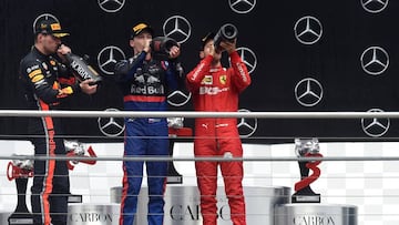 (L-R) Second placed Ferrari's German driver Sebastian Vettel, winner Red Bull's Dutch driver Max Verstappen and third placed Toro Rosso's Russian driver Daniil Kvyat celebrate with champagne on the podium after the German Formula One Grand Prix at the Hockenheim racing circuit on July 28, 2019 in Hockenheim, southern Germany. (Photo by Christof STACHE / AFP)