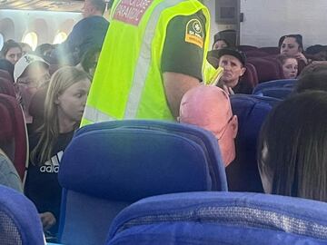 A paramedic walks onboard as passengers look on, after an incident on a LATAM Airlines Boeing 787, in Auckland, New Zealand, March 11, 2024, in this picture obtained from social media. Brian Adam Jokat/via REUTERS  THIS IMAGE HAS BEEN SUPPLIED BY A THIRD PARTY. MANDATORY CREDIT. NO RESALES. NO ARCHIVES.