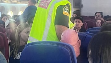 A paramedic walks onboard as passengers look on, after an incident on a LATAM Airlines Boeing 787, in Auckland, New Zealand, March 11, 2024, in this picture obtained from social media. Brian Adam Jokat/via REUTERS THIS IMAGE HAS BEEN SUPPLIED BY A THIRD PARTY. MANDATORY CREDIT. NO RESALES. NO ARCHIVES.