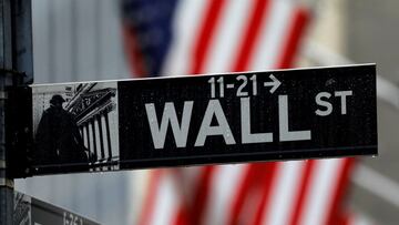 FILE PHOTO: Raindrops hang on a sign for Wall Street outside the New York Stock Exchange in Manhattan in New York City, New York, U.S., October 26, 2020. REUTERS/Mike Segar/File Photo