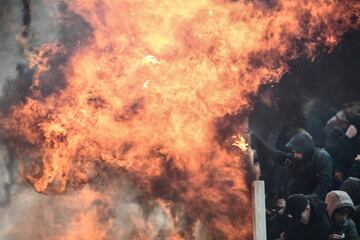 AEK Athens fans jumped onto the pitch and launched flares at the Ajax fans in the Champions League game in Greece on Tuesday night, causing police to intervene.