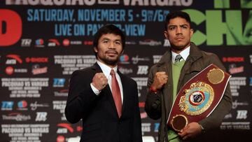 Boxers Manny Pacquiao (L) of the Philippines and Jessie Vargas of the US pose during their final news conference at The Wynn Las Vegas on November 2, 2016.  Pacquiao will challenge Vargas for the WBO Welterweight Championship title November 5, 2016 at the Thomas &amp; Mack Center in Las Vegas.  / AFP PHOTO / John GURZINSKI