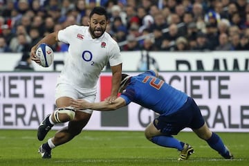 England's prop Mako Vunipola (L) is tackled by France's hooker and captain Guilhem Guirado.