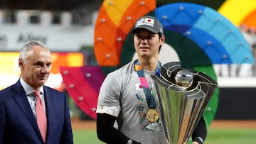 MIAMI, FLORIDA - MARCH 21: Shohei Ohtani #16 of Team Japan is awarded the trophy by Commissioner of Baseball Rob Manfred (L) after defeating Team USA in the World Baseball Classic Championship at loanDepot park on March 21, 2023 in Miami, Florida. Eric Espada/Getty Images/AFP (Photo by Eric Espada / GETTY IMAGES NORTH AMERICA / Getty Images via AFP)