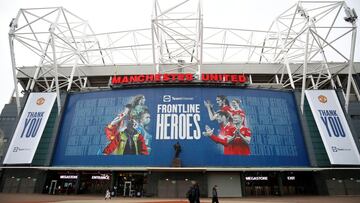 Soccer Football - People walk past Old Trafford after Manchester United&#039;s Premier League match against Brentford at the Brentford Community Stadium was postponed due to a number of positive coronavirus tests among players and staff, Manchester, Brita
