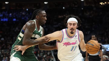 MILWAUKEE, WISCONSIN - JANUARY 23: Jaime Jaquez Jr. #11 of the Miami Heat is defended by Taurean Prince #12 of the Milwaukee Bucks during the second half of a game at Fiserv Forum on January 23, 2025 in Milwaukee, Wisconsin. NOTE TO USER: User expressly acknowledges and agrees that, by downloading and or using this photograph, User is consenting to the terms and conditions of the Getty Images License Agreement. Stacy Revere/Getty Images/AFP (Photo by Stacy Revere / GETTY IMAGES NORTH AMERICA / Getty Images via AFP)
