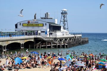 FILE PHOTO: A message reading 'Save Lives' is seen on Bournemouth Pier as people enjoy the hot weather on the beach, following the outbreak of the coronavirus disease (COVID-19), Bournemouth, Britain, June 2, 2020. REUTERS/Toby Melville/File Photo