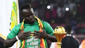 Senegal's forward Sadio Mane looks at the trophy prior to the ceremony after winning after the Africa Cup of Nations (CAN) 2021 final football match between Senegal and Egypt at Stade d'Olembe in Yaounde on February 6, 2022. (Photo by CHARLY TRIBALLEAU / AFP)