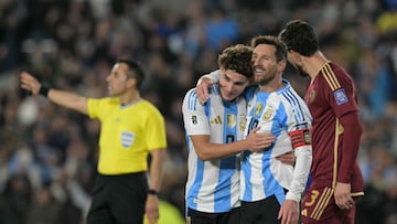 Argentina's forward #10 Lionel Messi celebrates with teammate forward #09 Julian Alvarez after scoring his team's first goal during the 2026 FIFA World Cup South American qualifiers football match between Argentina and Venezuela at the Mas Monumental stadium in Buenos Aires on September 4, 2025. (Photo by JUAN MABROMATA / AFP)