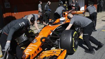 McLaren mechanics push the car of Fernando Alonso of Spain into the team box during a Formula One pre-season testing session at the Catalunya racetrack in Montmelo, outside Barcelona, Spain, Wednesday, March 1, 2017. (AP Photo/Francisco Seco)