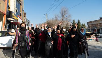 KABUL, AFGHANISTAN - DECEMBER 22:  Afghan women protest against new Taliban ban on women accessing University Education on December 22, 2022 in Kabul, Afghanistan. A group of Afghan women rallied in Kabul against a governmental order banning women from universities. Armed guards barred women from accessing university sites since the suspension was announced on December 20. (Photo by Stringer/Getty Images)