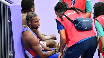 US' Noah Lyles speaks to medical staff after the men's 200m final of the athletics event at the Paris 2024 Olympic Games at Stade de France in Saint-Denis, north of Paris, on August 8, 2024. (Photo by Martin BERNETTI / AFP)