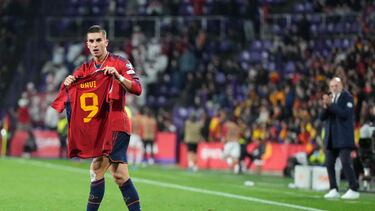 Spain's midfielder #11 Ferran Torres holds the jersey of teammate Spain's midfielder #09 Gavi as he celebrates scoring his team's second goal during the UEFA Euro 2024 group A qualifying football match between Spain and Georgia at the Jose Zorrilla stadium in Valladolid on November 19, 2023. (Photo by CESAR MANSO / AFP)