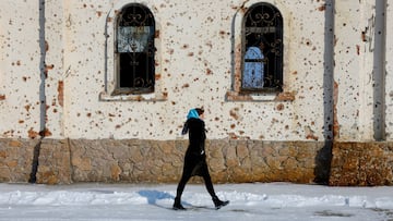 A woman walks outside St. Iveron Convent, which was heavily damaged by artillery and gun fire during battles for the local airport in the course of Russia-Ukraine conflict, in Donetsk, a Russian controlled region of Ukraine, February 25, 2025. REUTERS/Alexander Ermochenko TPX IMAGES OF THE DAY