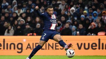 Paris Saint-Germain's French forward Kylian Mbappe shoots to score his team's third goal during the French L1 football match between Olympique Marseille (OM) and Paris Saint-Germain (PSG) at the Velodrome stadium in Marseille, southern France on February 26, 2023. (Photo by CHRISTOPHE SIMON / AFP)