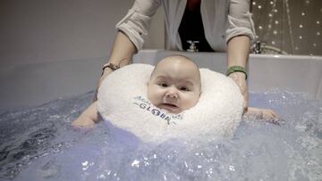 A baby is seen during a spa session at a swimming school in Istanbul, Turkey.