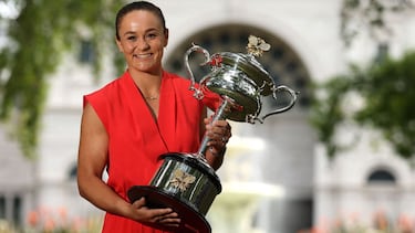 (FILE) In this file photo taken on January 30, 2022 Australia's Ashleigh Barty poses with the 2022 Australian Open winner's trophy in Melbourne on January 30, 2022, following her victory over Danielle Collins of the US in the women's singles final of the
