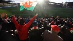 Supporters celebrate Wrexham Association Football Club's first goal during a National League fixture football match against Maidenhead United, at the Racecourse Ground stadium, in Wrexham
