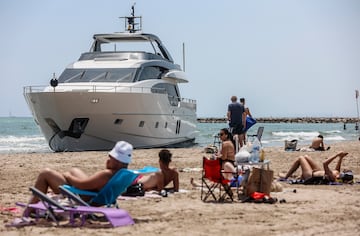 Bañistas en la Playa de Pinedo delante de un yate varado con la bandera de Gran Bretaña, a 5 de junio de 2024, en Valencia.
Rober Solsona / Europa Press