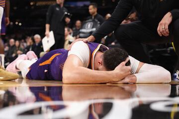 Jusuf Nurkic tendido en el suelo tras recibir un golpe por parte de Draymond Green.