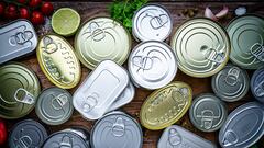 Overhead view of a large group of canned food shot on wooden table. High resolution 42Mp studio digital capture taken with Sony A7rII and Zeiss Batis 40mm F2.0 CF lens