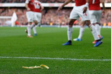 A banana skin thrown from the crowd is seen at the side of the pitch as Arsenal's Gabonese striker Pierre-Emerick Aubameyang celebrates after scoring the opening goal from the penalty spot.