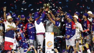 Players from Dominican Republic's Leones del Escogido hold the trophy after their victory over Mexico's Charros de Jalisco in the Caribbean Series baseball tournament first place play-off game between Dominican Republic and Mexico at Estadio El Nido De Los Aguilas in Mexicali, Baja California state, Mexico on February 8, 2025. (Photo by FAUSTO IBARRA / AFP)