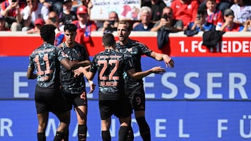 Bayern Munich's English forward #09 Harry Kane (R) celebrates scoring the opening goal with his teammates during the German first division Bundesliga football match between Heidenheim and Bayern Munich in Heidenheim, southern Germany on April 19, 2025. (Photo by THOMAS KIENZLE / AFP) / DFL REGULATIONS PROHIBIT ANY USE OF PHOTOGRAPHS AS IMAGE SEQUENCES AND/OR QUASI-VIDEO