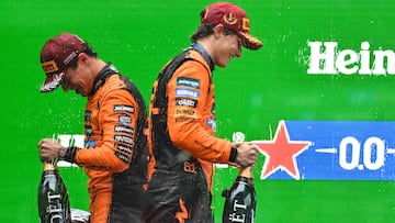 Winner McLaren's Australian driver Oscar Piastri (R) and second-placed McLaren's British driver Lando Norris (L) celebrate on the podium after the Formula One Chinese Grand Prix at the Shanghai International Circuit in Shanghai on March 23, 2025. (Photo by Hector RETAMAL / AFP)