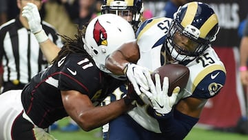 GLENDALE, AZ - OCTOBER 02: Strong safety T.J. McDonald #25 of the Los Angeles Rams intercepts a pass in front of wide receiver Larry Fitzgerald #11 of the Arizona Cardinals during the second half of the NFL game against the Los Angeles Rams at University of Phoenix Stadium on October 2, 2016 in Glendale, Arizona. The Los Angeles Rams won 17-13.   Norm Hall/Getty Images/AFP
 == FOR NEWSPAPERS, INTERNET, TELCOS &amp; TELEVISION USE ONLY ==