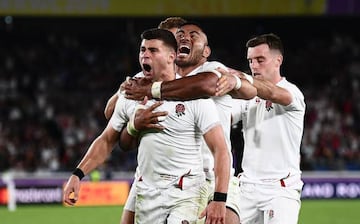 England's scrum-half Ben Youngs (L) celebrates with England's centre Henry Slade (back L), England's centre Manu Tuilagi and England's fly-half George Ford (R)