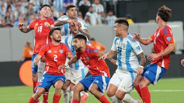 Jun 25, 2024; East Rutherford, NJ, USA; Argentina defender Nicolas Tagliafico (3) and forward Lautaro Martinez (22) battle Chile defender Gabriel Suazo (2) and defender Paulo Diaz (5) for the ball during the second half at MetLife Stadium. Mandatory Credit: Vincent Carchietta-USA TODAY Sports