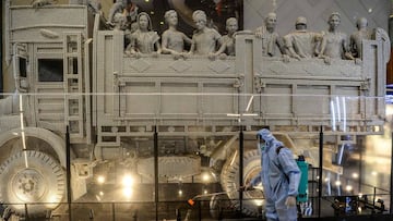 A cleaning staff wearing a Personal Protective Equipment (PPE) suit sprays disinfectant inside the High Street Phoenix mall ahead of the reopening of malls while other restrictions are maintained against the spread of the COVID-19 coronavirus, in Mumbai o