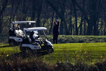 President Donald Trump waves as he plays golf at his club on November 14, 2020