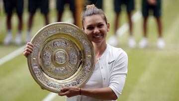 Simona Halep of Romania with the championship trophy as she celebrates her victory over Serena Williams of the US in the women's final of the Wimbledon Championships at the All England Lawn Tennis Club