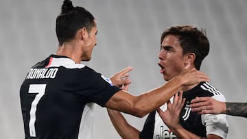 Juventus' Argentine forward Paulo Dybala (R) celebrates with Juventus' Portuguese forward Cristiano Ronaldo after opening the scoring during the Italian Serie A football match Juventus vs Lecce played on June 26, 2020 behind closed doors at the