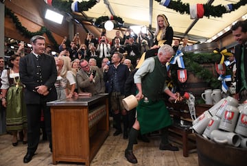 Bavaria's State Premier Markus Soeder watches as Munich mayor Dieter Reiter taps the first barrel of beer to officially open the world's largest beer festival, the 187th Oktoberfest in Munich, Germany, September 17, 2022. REUTERS/Andreas Gebert