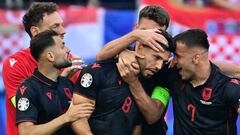 Albania's midfielder #08 Klaus Gjasula celebrates with his team mates after scoring the equalising goal 2:2 during the UEFA Euro 2024 Group B football match between Croatia and Albania at the Volksparkstadion in Hamburg on June 19, 2024. (Photo by JOHN MACDOUGALL / AFP)