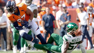 Noah Fant #87 of the Denver Broncos is tackled by C.J. Mosley #57 of the New York Jets at Empower Field At Mile High on September 26, 2021, in Denver, Colorado. 