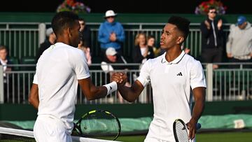 Tennis - Wimbledon - All England Lawn Tennis and Croquet Club, London, Britain - July 3, 2023 Michael Mmoh of the U.S. shakes hands with Canada's Felix Auger Aliassime after winning his first round match REUTERS/Dylan Martinez