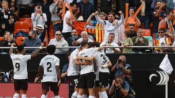 Valencia's players celebrate the opening goal scored by Spanish forward Diego Lopez during the Spanish league football match between Valencia CF and Real Madrid CF at the Mestalla stadium in Valencia on May 21, 2023. (Photo by JOSE JORDAN / AFP)