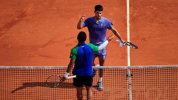 Spain's Carlos Alcaraz (TOP) greets France's Arthur Fils after winning the Monte Carlo ATP Masters Series Tournament quarter-final tennis match on the Rainier III court at the Monte Carlo Country Club in Roquebrune-Cap-Martin on April 11, 2025. (Photo by Valery HACHE / AFP)