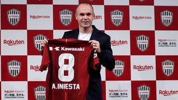 Spain midfielder Andres Iniesta poses with his T-shirt at a news conference to announce signing for J-League side Vissel Kobe in Tokyo, Japan May 24, 2018.  REUTERS/Toru Hanai