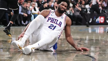 Philadelphia 76ers center Joel Embiid (21) grimaces after falling to the floor