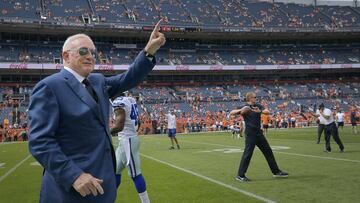 Dallas Cowboys owner Jerry Jones takes the field while head coach Jason Garrett plays catch in the background before a game against the Denver Broncos on Sunday, Sept. 17, 2017 at Sports Authority Field at Mile High in Denver, Colo. (Max Faulkner/Fort Worth Star-Telegram/TNS via Getty Images)