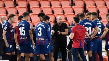 Levante's Spanish coach Paco Lopez (C) speaks with his players during the Spanish League football match between Valencia and Levante at the Mestalla stadium in Valencia on June 12, 2020. (Photo by JOSE JORDAN / AFP)