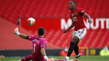 MANCHESTER, ENGLAND - JULY 13: Alex McCarthy of Southampton saves a shot from Anthony Martial of Manchester United during the Premier League match between Manchester United and Southampton FC at Old Trafford on July 13, 2020 in Manchester, England. Footba